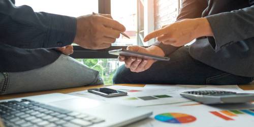 deux hommes préparant le bilan prévisionnel de l'entreprise pour lever des fonds